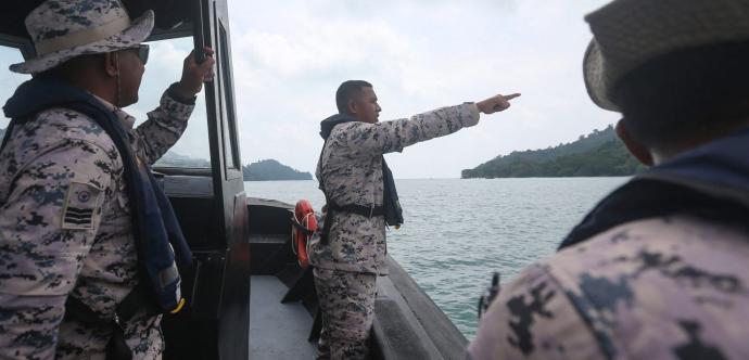 Des responsables maritimes malaisiens recherchent des survivants après le chavirement d’un bateau transportant des migrant·e·s en provenance du Myanmar.