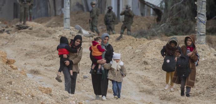 Des familles se déplacent sous le regard de soldats
