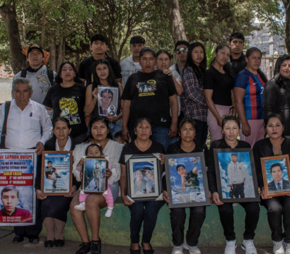 Des proches des victimes tenant des portraits de leurs proches décédés..